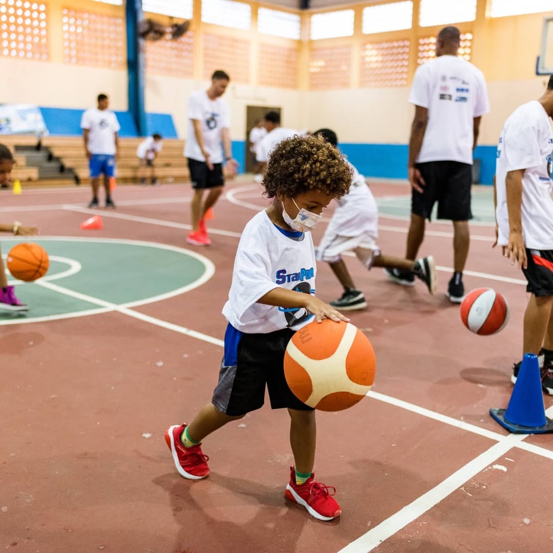 A young player dribbling through cone drills with StarPower coaches at the Vieques court